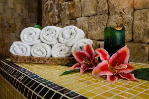 a pile of towels and flowers on a table at Coto del Valle de Cazorla in Cazorla +17 photos
