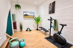 a gym with exercise equipment in a room at " Verdun Paradise " Jardin - Salle de Sport - Salle de Jeux in Verdun-sur-Garonne