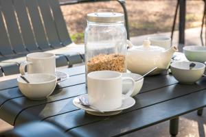 a table with cups and a jar of food on it at Montjoia in L'Isle-sur-la-Sorgue