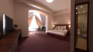 a bedroom with a bed and a television in a room at Passage Hotel Restaurant in Goris
