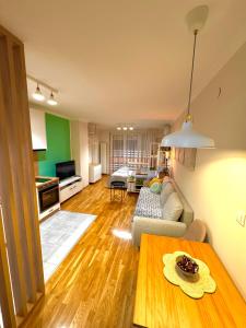 a living room with a couch and a table at Studio 4 in Pirot