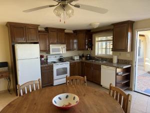 a kitchen with wooden cabinets and a wooden table at Casa Stu Playa de Oro Rental in San Felipe