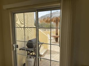 a view of a window with a dog looking out at Casa Stu Playa de Oro Rental in San Felipe