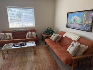 a living room with two couches and a coffee table at Casa Stu Playa de Oro Rental in San Felipe