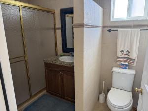 a bathroom with a toilet and a sink at Casa Stu Playa de Oro Rental in San Felipe +11 photos