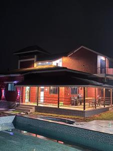 a house with a swimming pool in front of a building at BlueSea Villa Kashid beach in Kashid