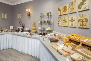 a bakery counter with a lot of bread and pastries at Best Western Plus Hotel Villa D'est in Strasbourg
