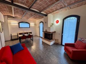 a living room with a red couch and a fireplace at Casa Barovaldo in Zola Predosa
