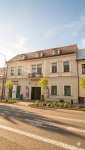 a large building on the side of a street at Boutique Hotel H23 in Pezinok +13 photos