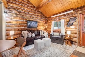 a log cabin living room with a couch and chairs at Pinecrest Cabin- Serene Black Hills Getaway in Rapid City