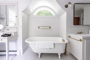 a white bathroom with a tub and a sink at Mystic Landing in Kennebunk +48 photos