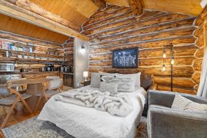 a bedroom with a bed and a wooden wall at Pinecrest Cabin- Serene Black Hills Getaway in Rapid City +27 photos