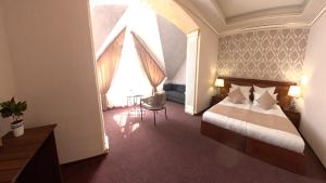 a hotel room with a bed and a large window at Passage Hotel Restaurant in Goris