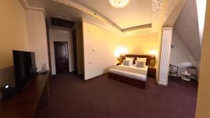 a hotel room with a bed and a television at Passage Hotel Restaurant in Goris +37 photos