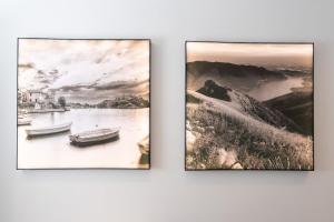 three framed photographs of a river and a boat at DN ART BLEVIO - Romantic Lake Como Apartment with Indoor Jacuzzi - 5 guests in Blevio