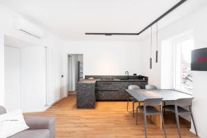 a living room with a table and chairs at DN ART BLEVIO - Romantic Lake Como Apartment with Indoor Jacuzzi - 5 guests in Blevio