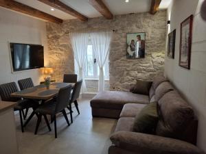a living room with a couch and a table at Apartments Jerko in Primošten
