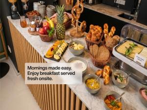 a buffet with many different types of food on a counter at Numa Berlin Drift in Berlin +34 photos