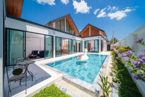 an exterior view of a house with a swimming pool at Yuan Villa VIP in Rawai Beach
