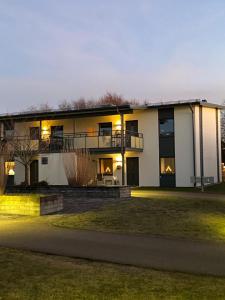 a large white house with a lawn in front of it at Nära strand och hav in Halmstad