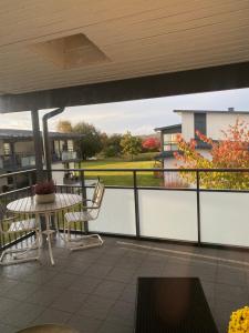 a patio with a table and chairs on a balcony at Nära strand och hav in Halmstad +2 photos