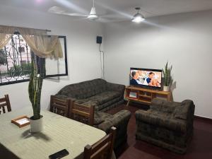 a living room with a couch and a tv at Jerarquizado M Rentals in Santiago del Estero