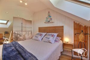 a bedroom with a bed with white sheets and pillows at L'araukaria in Tressignaux