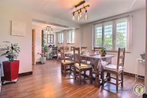 a dining room with a table and chairs at L'araukaria in Tressignaux