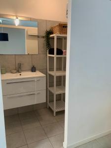 a small kitchen with a sink and a shelf at Les Toits d'Aniane in Aniane