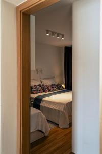 a reflection of a bedroom with two beds in a mirror at Cyklo Apartmán Třeboň in Třeboň