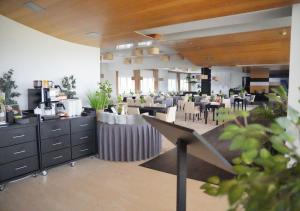 a restaurant with tables and chairs in a room at Platinum Ostróda in Ostróda