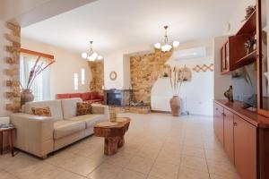 a living room with a couch and a table at Villa Geomare in Apolakkiá