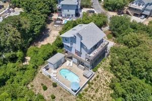an aerial view of a house with a swimming pool at Dock Holiday OBX Village in Duck