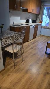 a kitchen with a table and a chair in a kitchen at Apartament Riva in Rowy