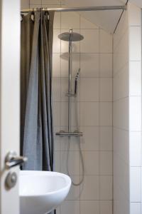 a bathroom with a sink and a shower curtain at Achterom in Biggekerke +13 photos