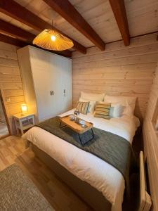 a bedroom with a large bed in a wooden room at Chalet Zen Imatra Lake Villa in Imatra
