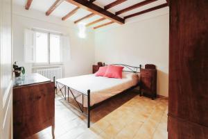 a bedroom with a bed with a red pillow on it at historical townhome in Poppi in Poppi