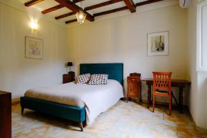 a bedroom with a bed and a desk and a chair at historical townhome in Poppi in Poppi