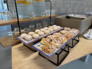 a display of donuts on a counter in a bakery at Hotel Aréna in Jihlava