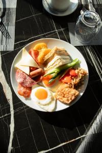 a plate of breakfast food on a table at Luwian Athens Boutique Hotel in Athens