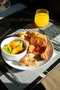 a plate of food with a bowl of bread and fruit at Luwian Athens Boutique Hotel in Athens