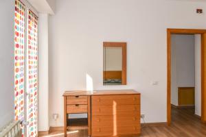 a bedroom with a dresser and a mirror on a wall at Da Nonna Mena in Fossacesia