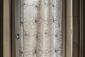a window with a curtain with butterflies on it at Da Nonna Mena in Fossacesia