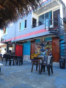 a group of tables and chairs in front of a building at Hotel Pablo's in Tumaco