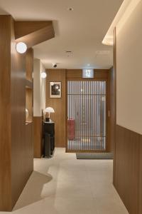 a hallway with a door with a gate in a building at Hotel On You in Seoul