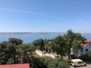 a van parked in a parking lot next to a body of water at Nadalina 10 in Starigrad +5 photos