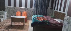 a lego room with a bed and a sink at Astha Restorent & Geust House in Aonla
