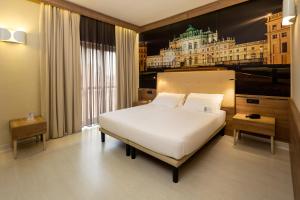 a bedroom with a white bed and a large window at Best Western Hotel Luxor in Turin +93 photos