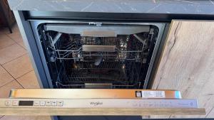 a dishwasher with its door open with the dishes inside at Bilocale baciato dal sole in Andalo