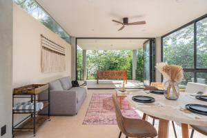 a living room with a table and a couch at Limas in Tulum
